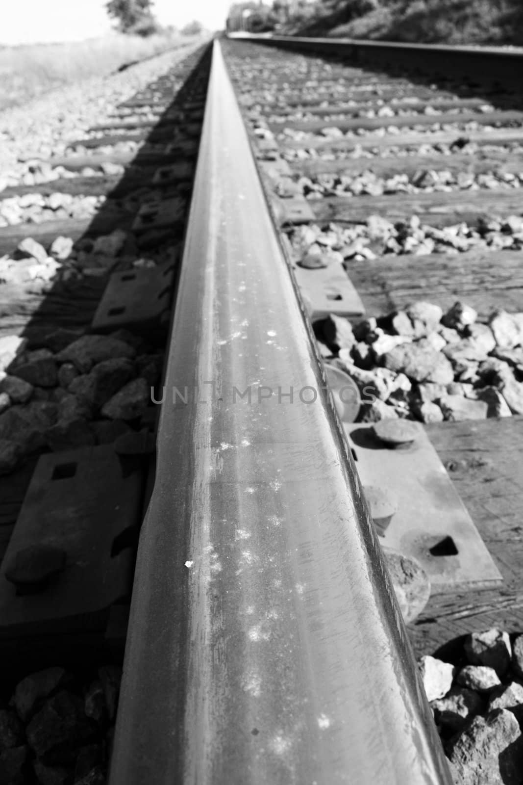 Close up of a rail track going into the horizon.