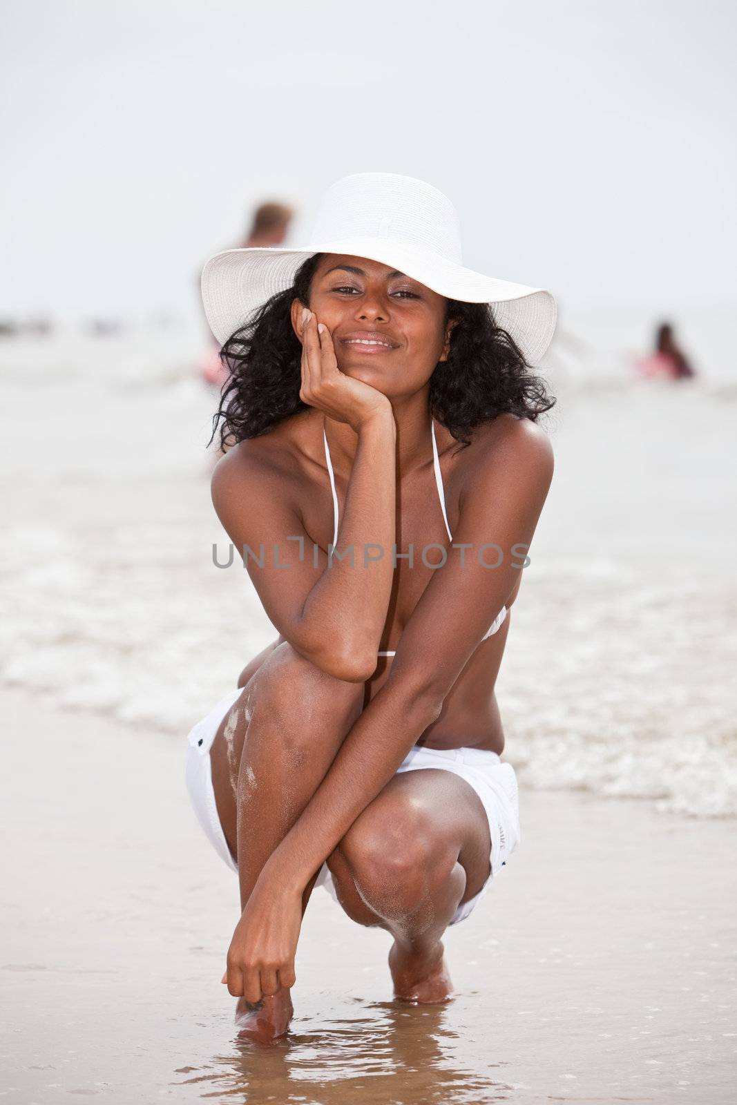 Beautiful brazilian girl with radiant smile relaxing by the waterside