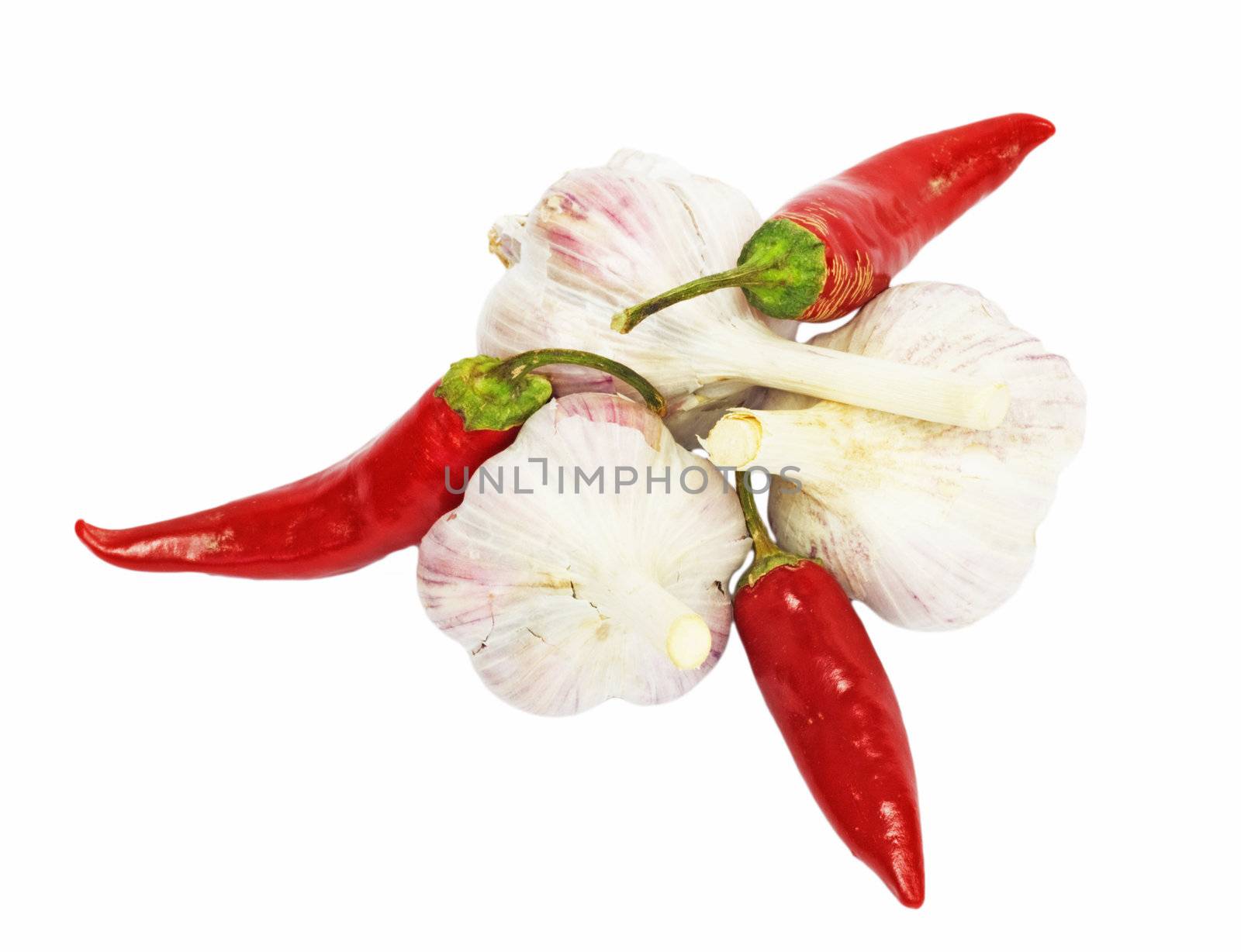 red chili pepper with garlic on white  by schankz
