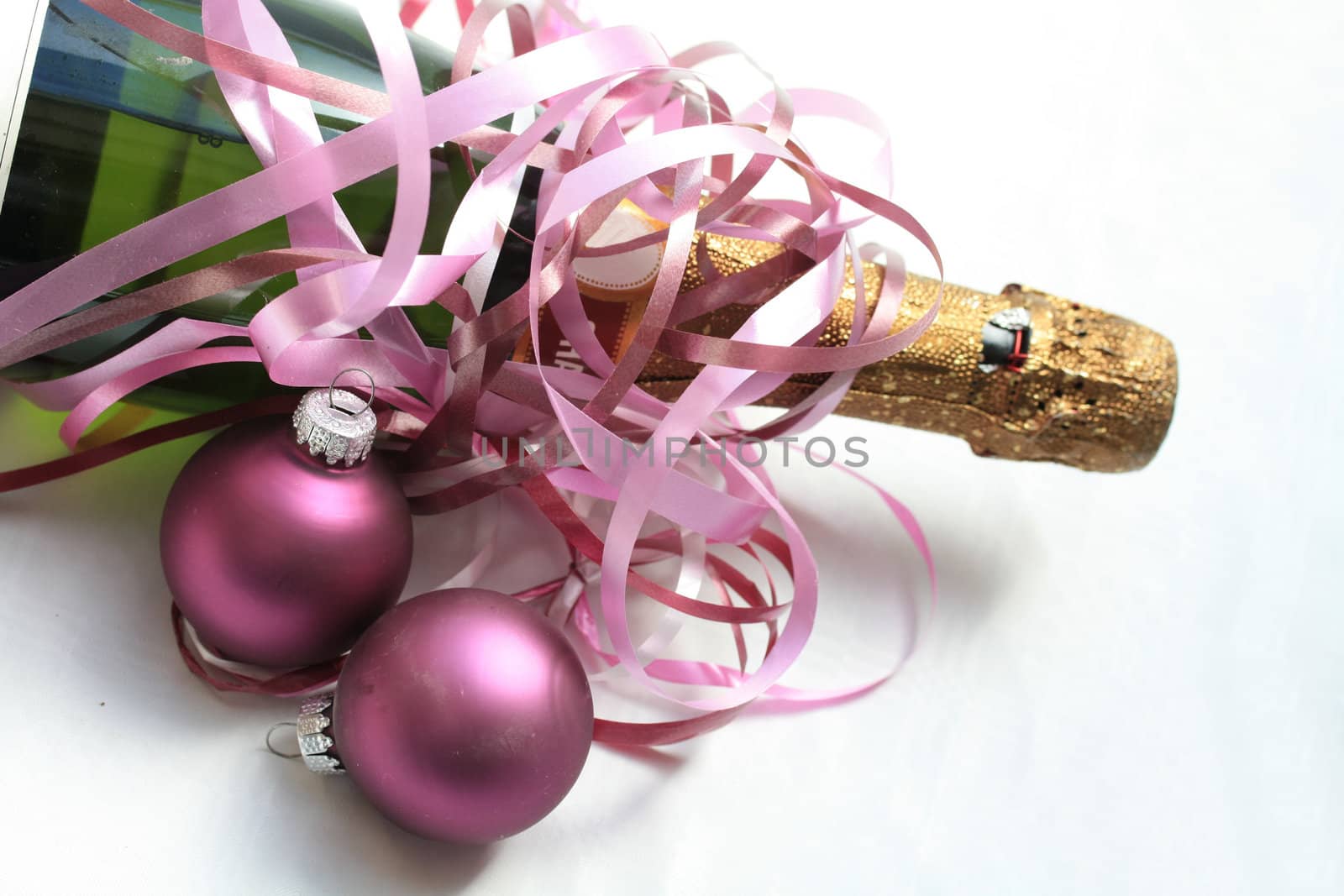 Bottle of champagne and purple christmas ornaments