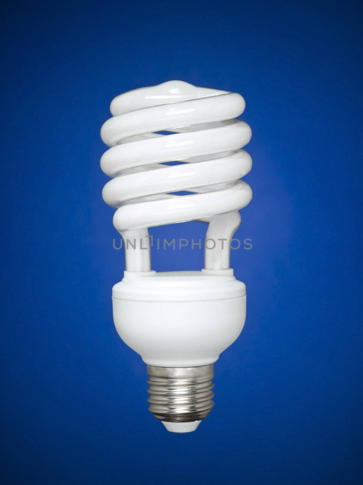 Compact fluorescent light bulb isolated over blue background.