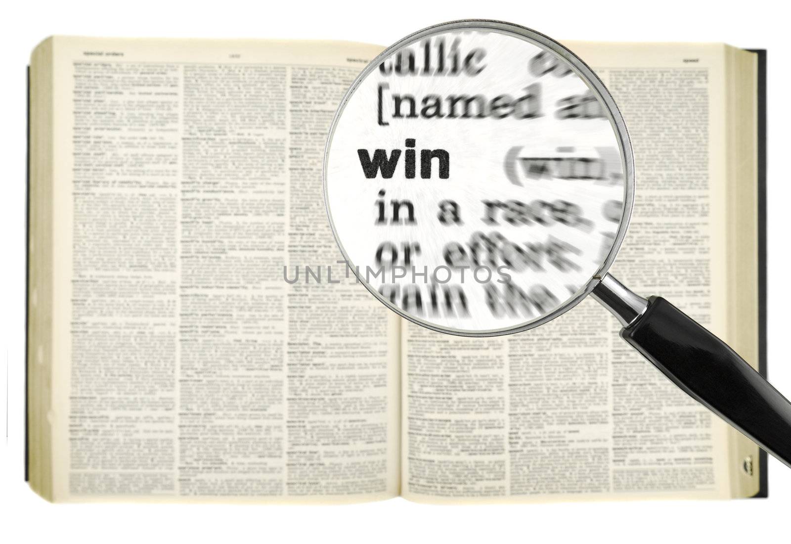 A magnifying glass on the word WIN on a dictionary. Isolated on white.
