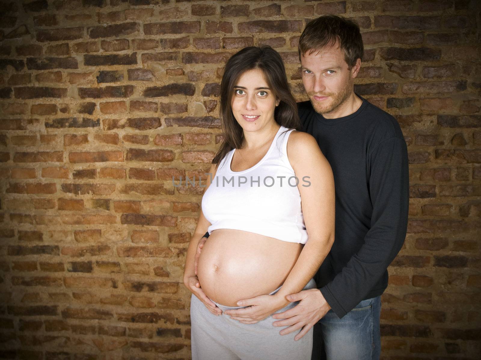 Young couple waiting for a baby. Eighth month pregnancy.