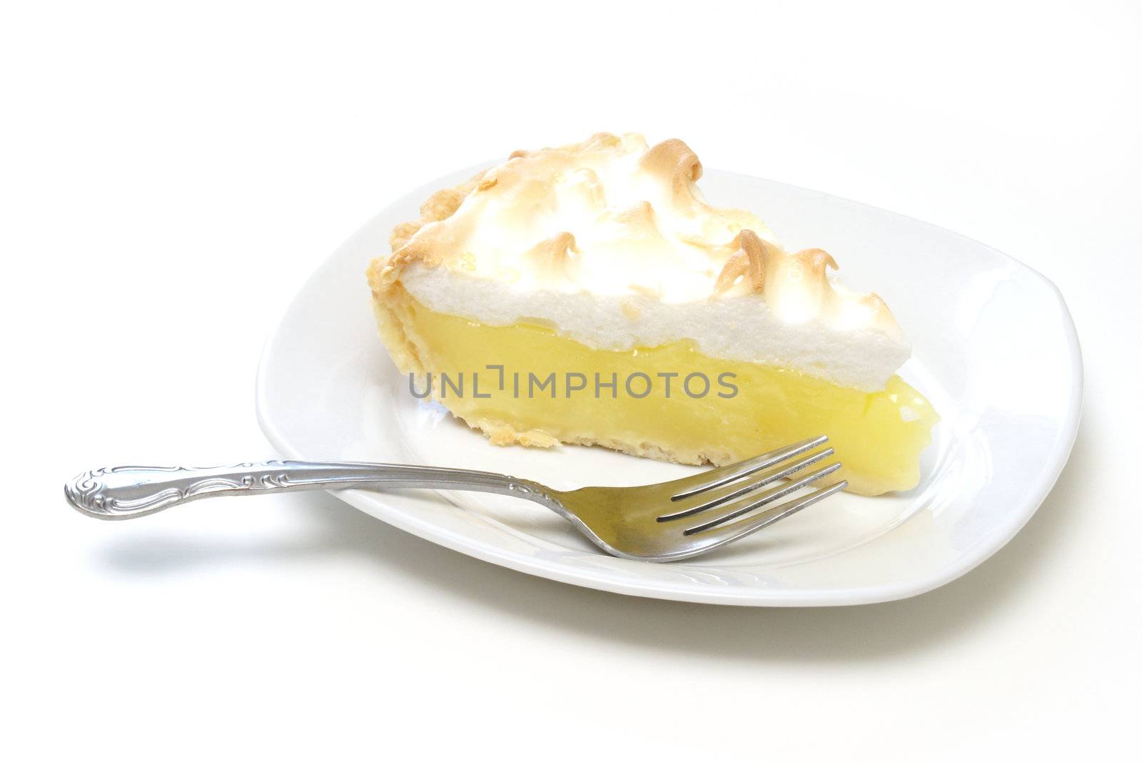 An isolated slice of lemon meringue pie.