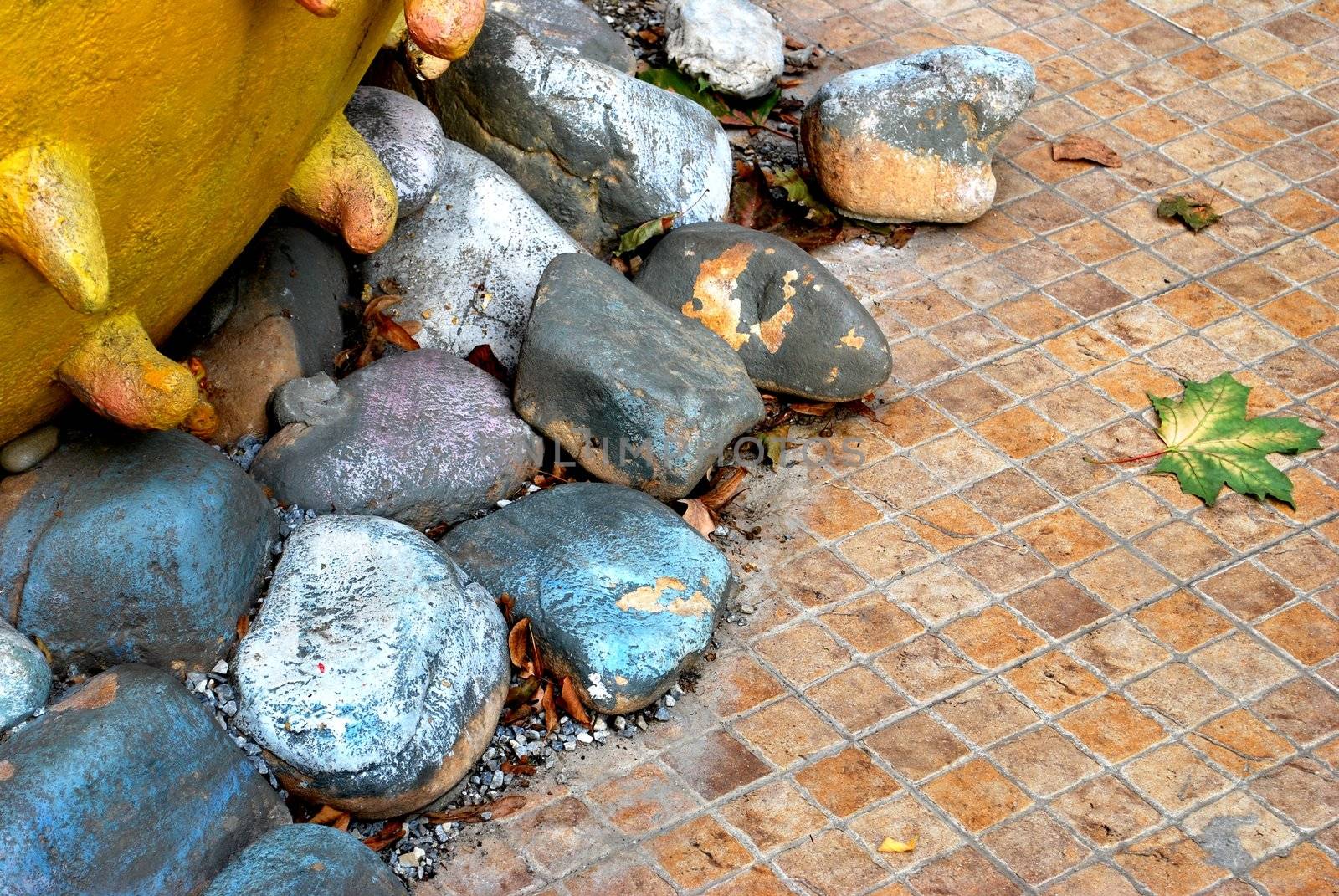 Composition with colored stones, strange artifact and autumn leave