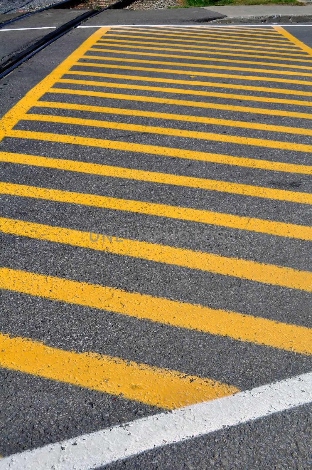 Yellow strips painted on street at railroad crossing