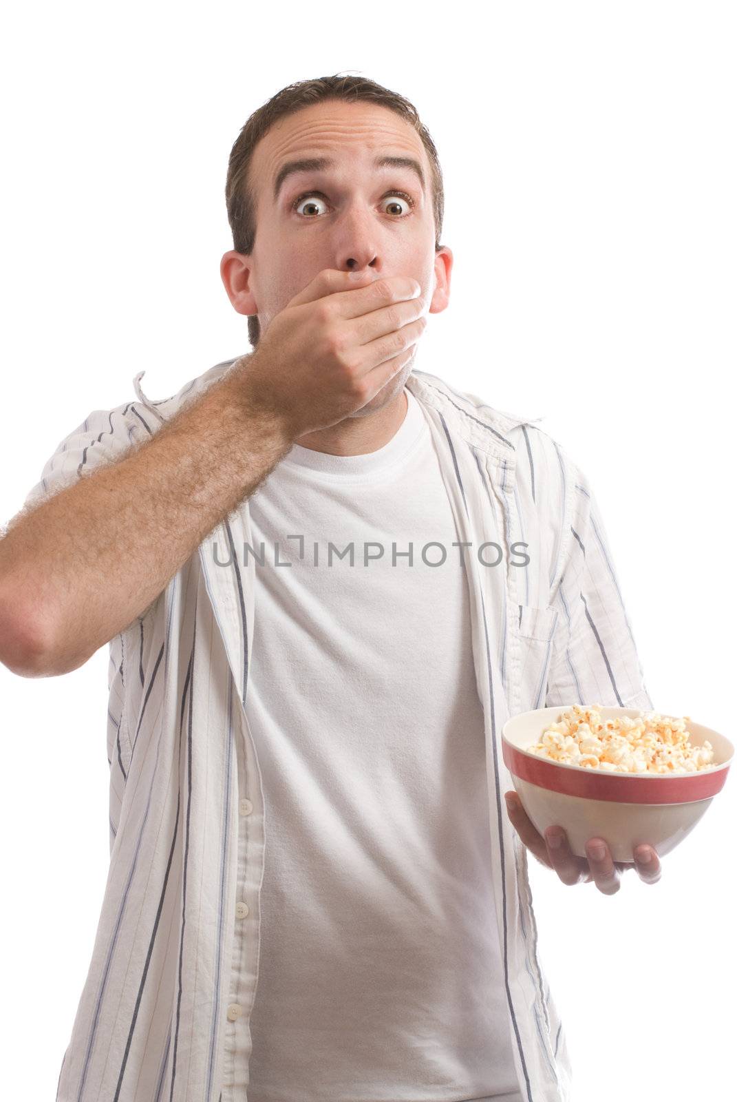 A man eating handfulls of popcorn from a bowl, isolated against a white background