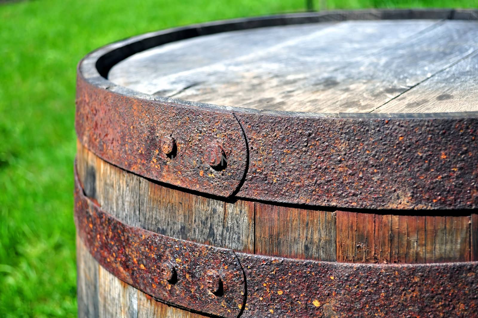 Detail of rusty metal on wood barrel