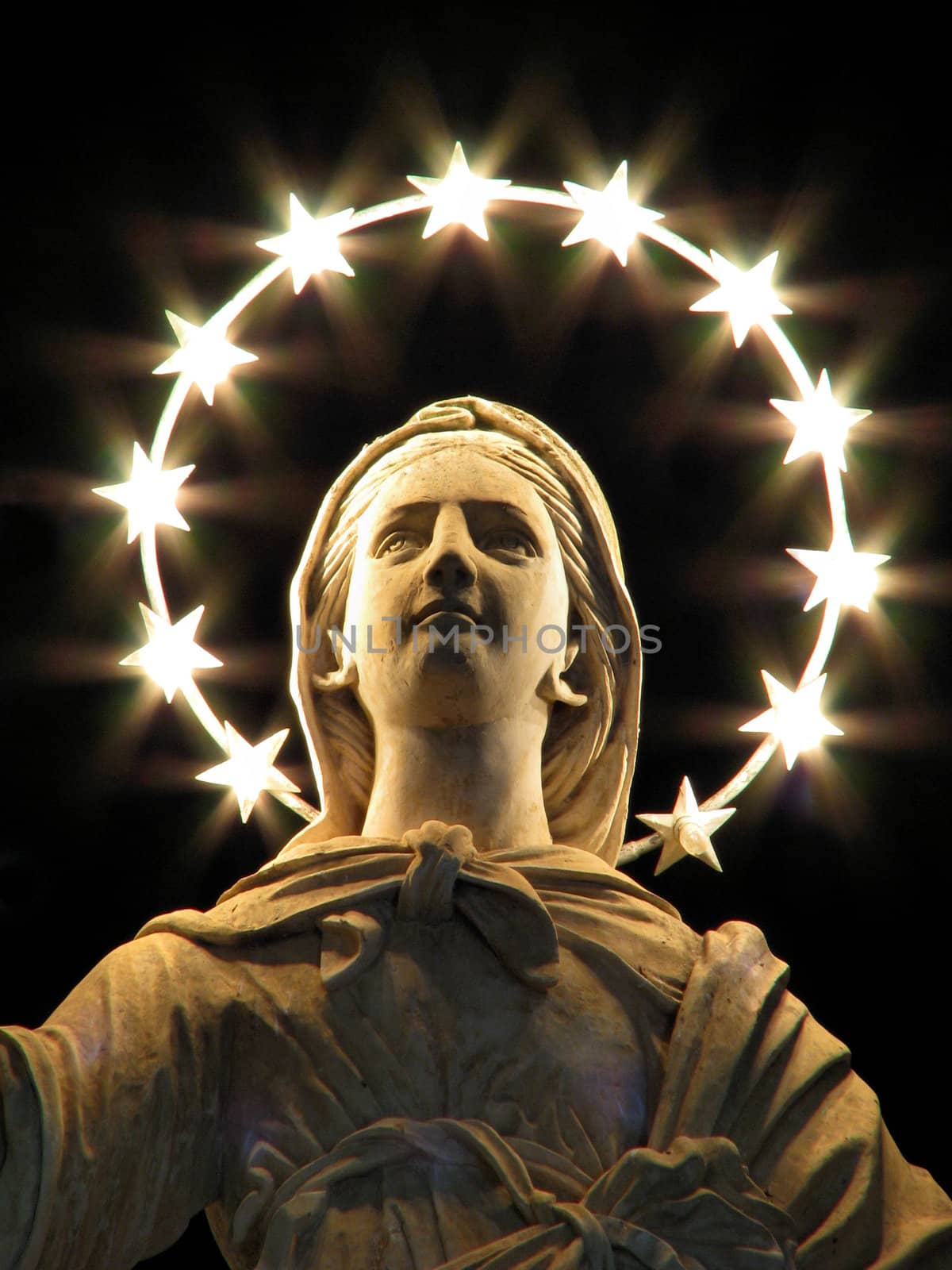 A statue of Saint Mary carved in stone in the village square of Qrendi, Malta.