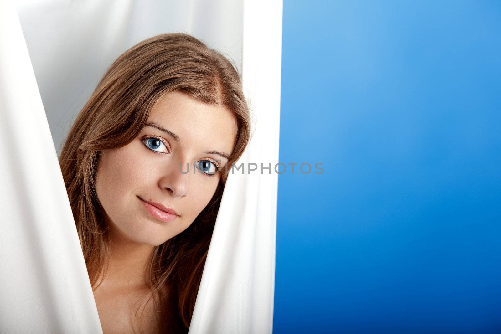 Portrait of Fresh and Beautiful young woman over a blue background