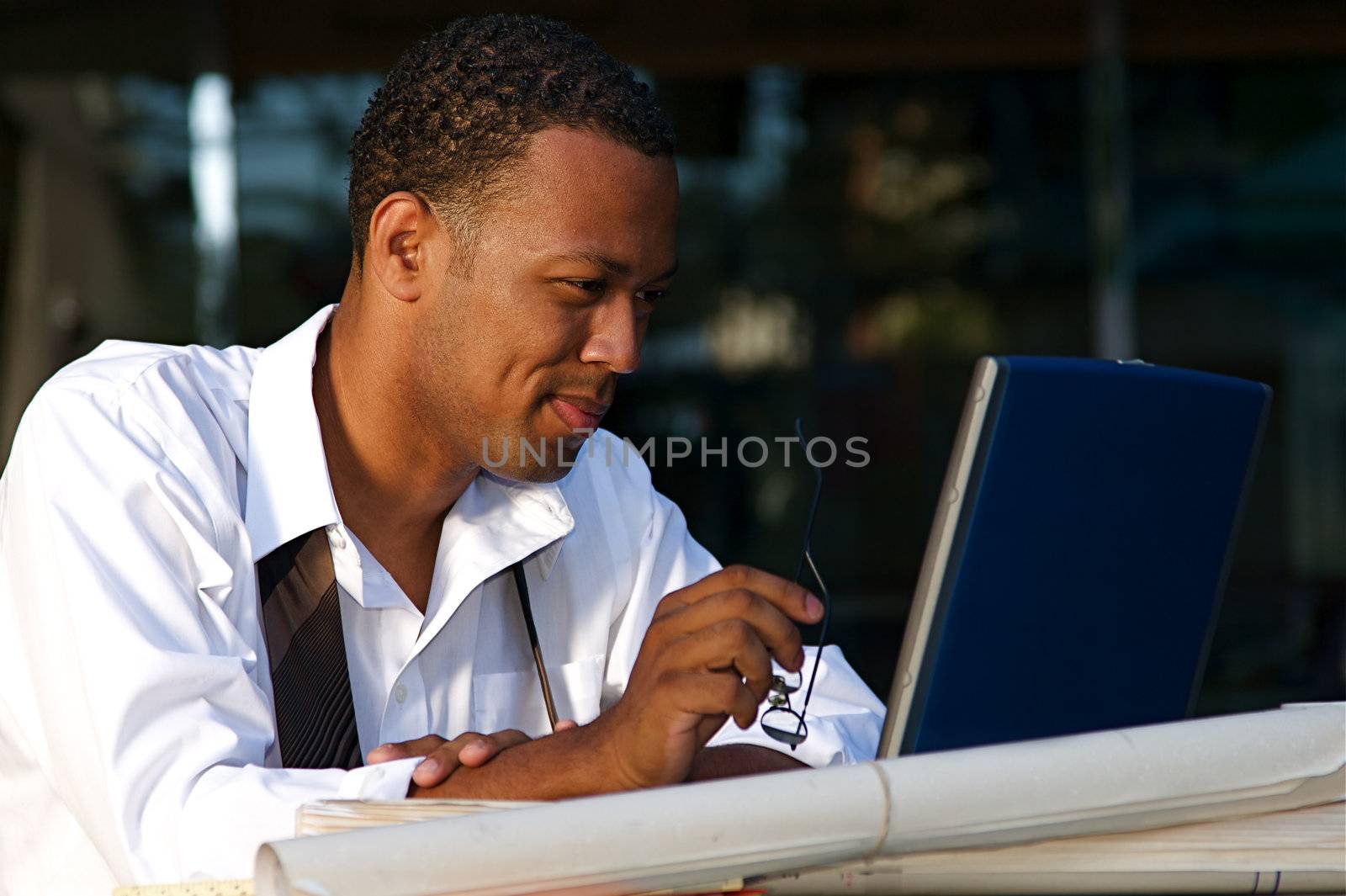 Young Businessman works on a computer outdoors