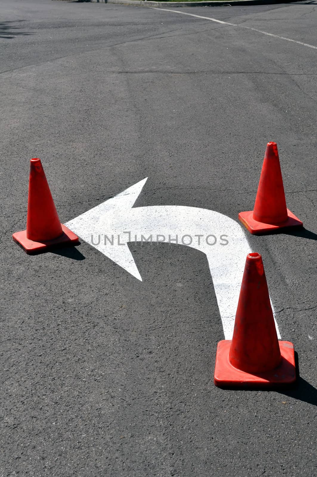 Turn left sign with cones, fresh paint.