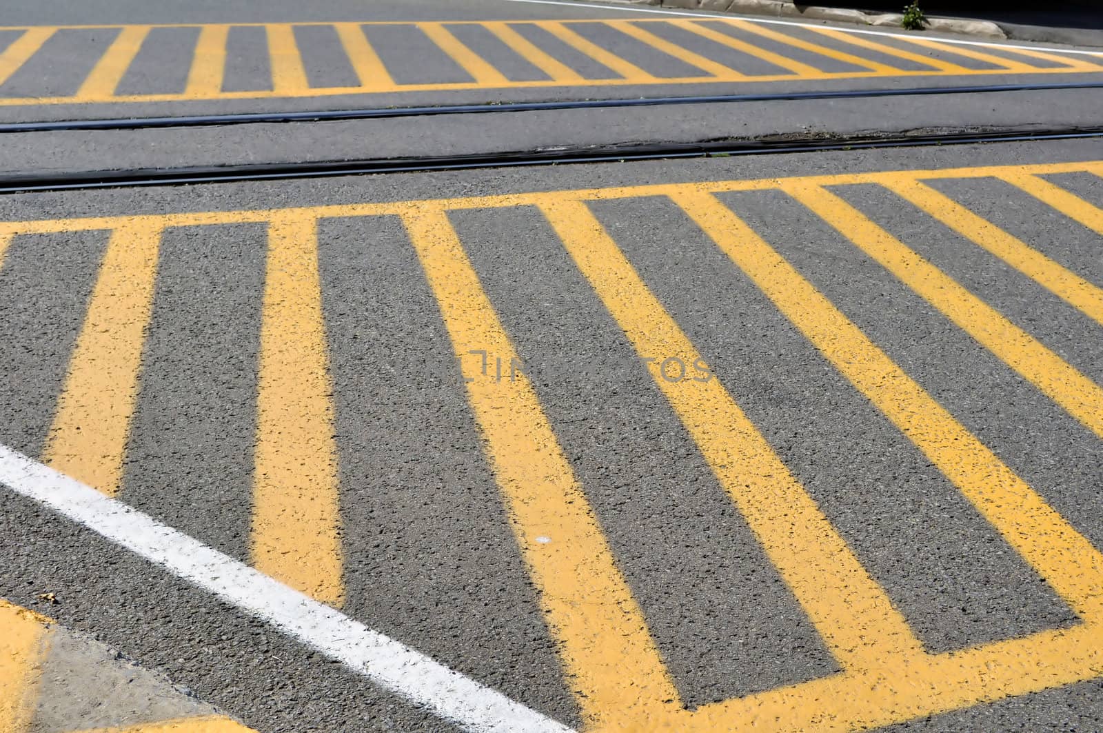 Yellow strips painted on street at railroad crossing