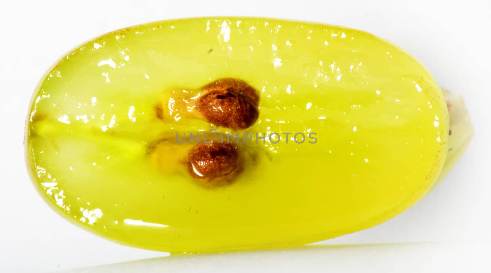 Translucent slice of green grape fruit, macro isolated on white 