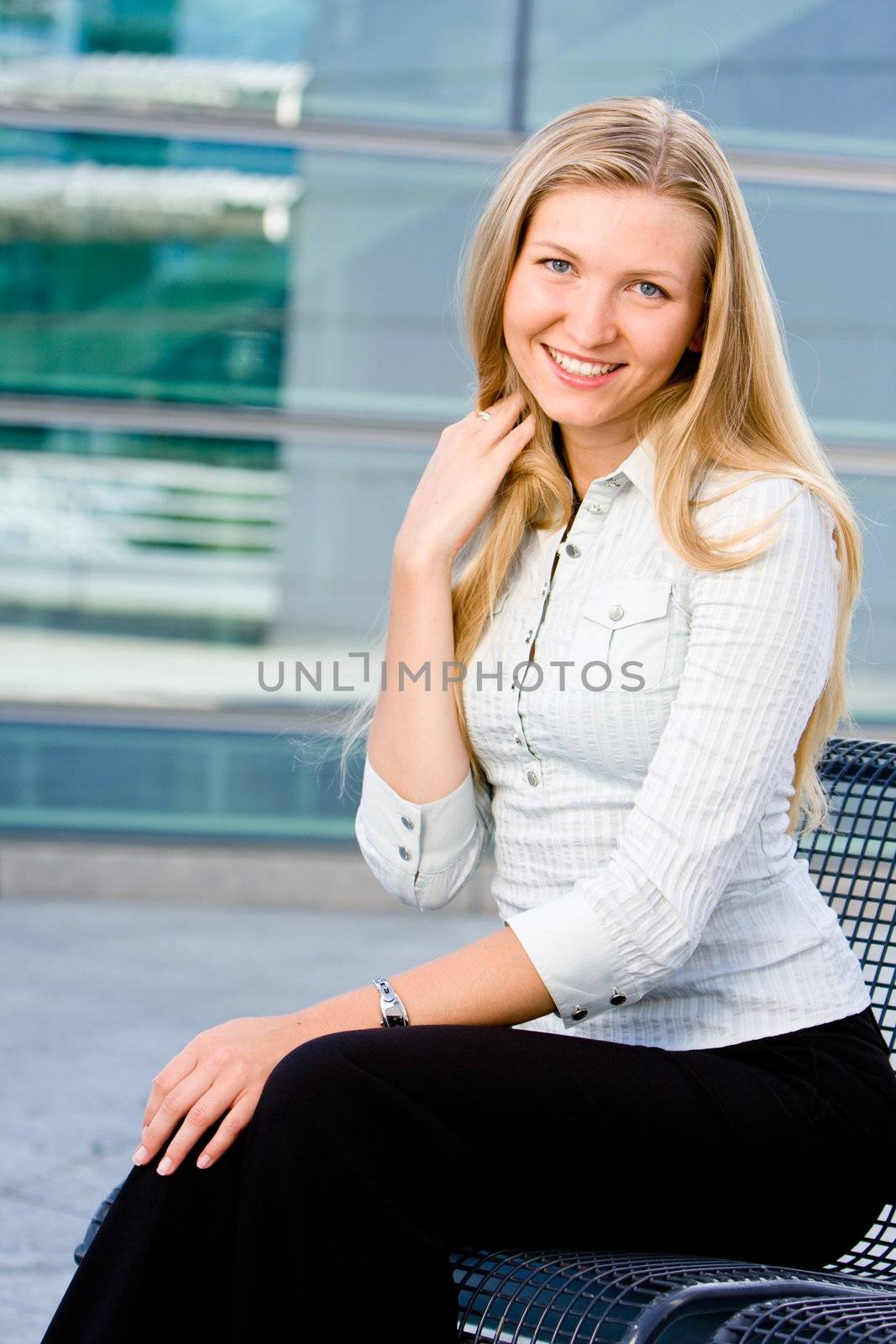 Beautiful attractive blonde business woman looking at you being sweet