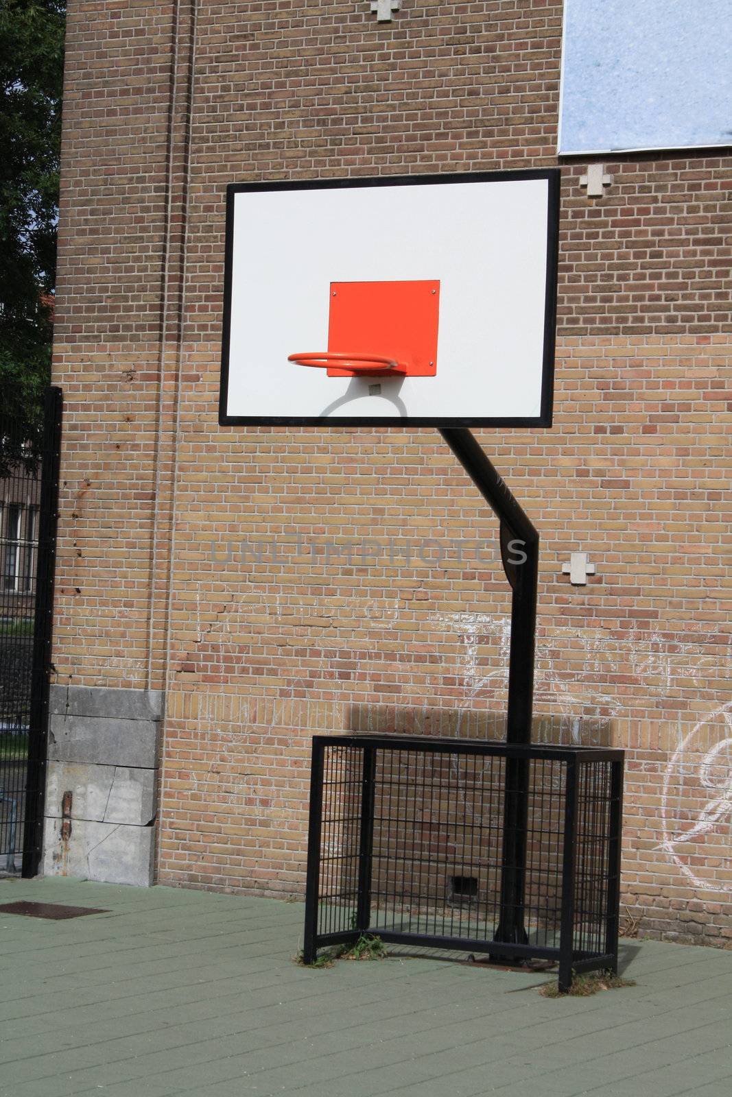A basket ball board on a school yard playground