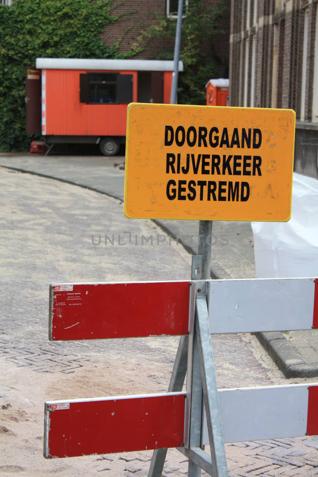 Warning sign near road construction  by studioportosabbia