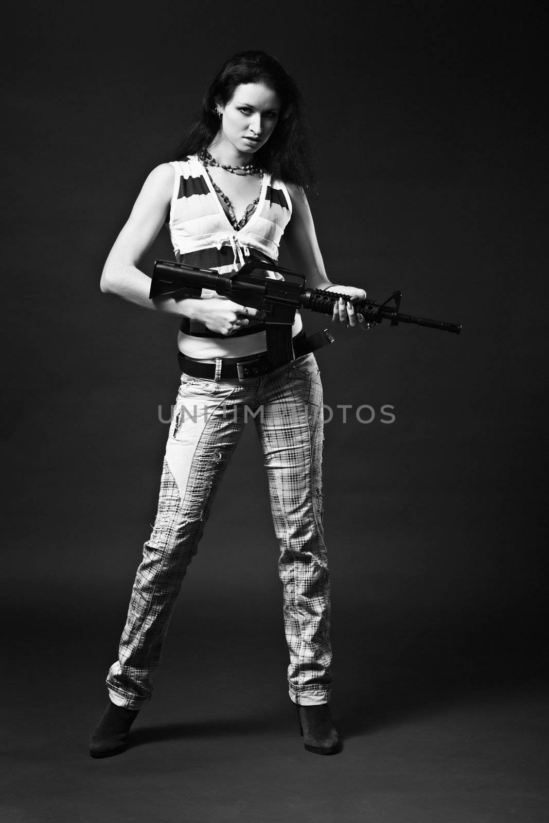 A girl holding a rifle - a contrast monochrome picture