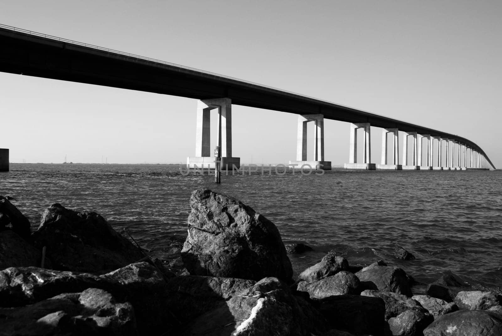 Long modern bridge built over a river.