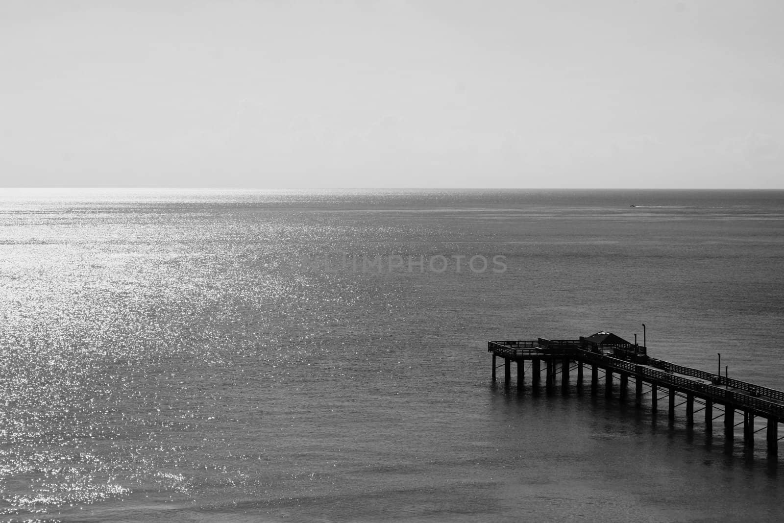 Big long pier on a sunny day.