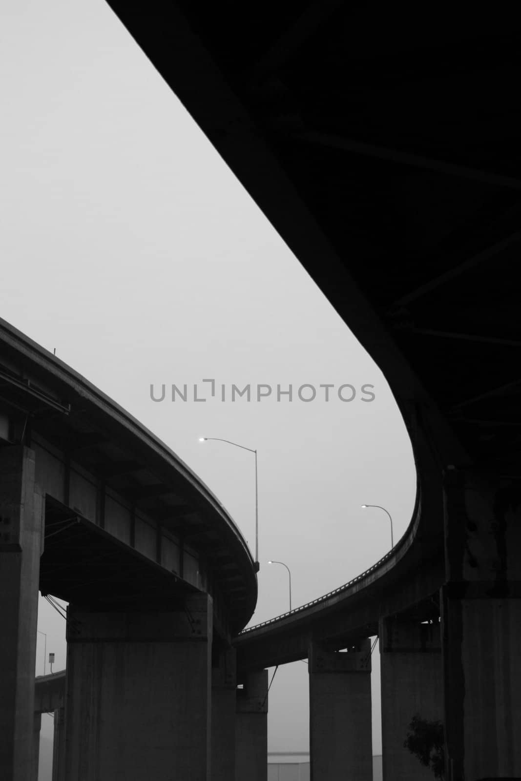 Close up of the empty freeway ramps in a fog.