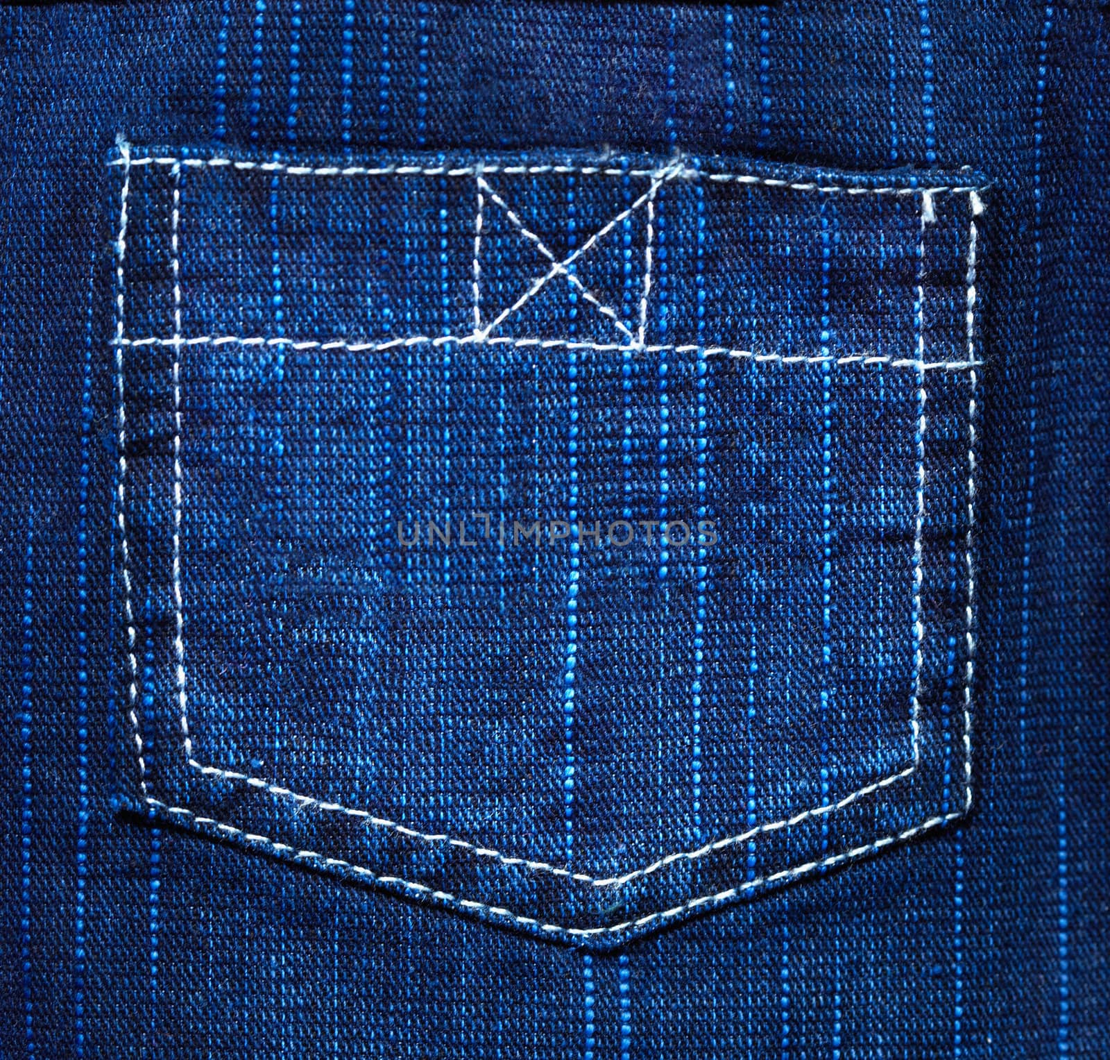 Back pocket of jeans - the background of rough blue fabric