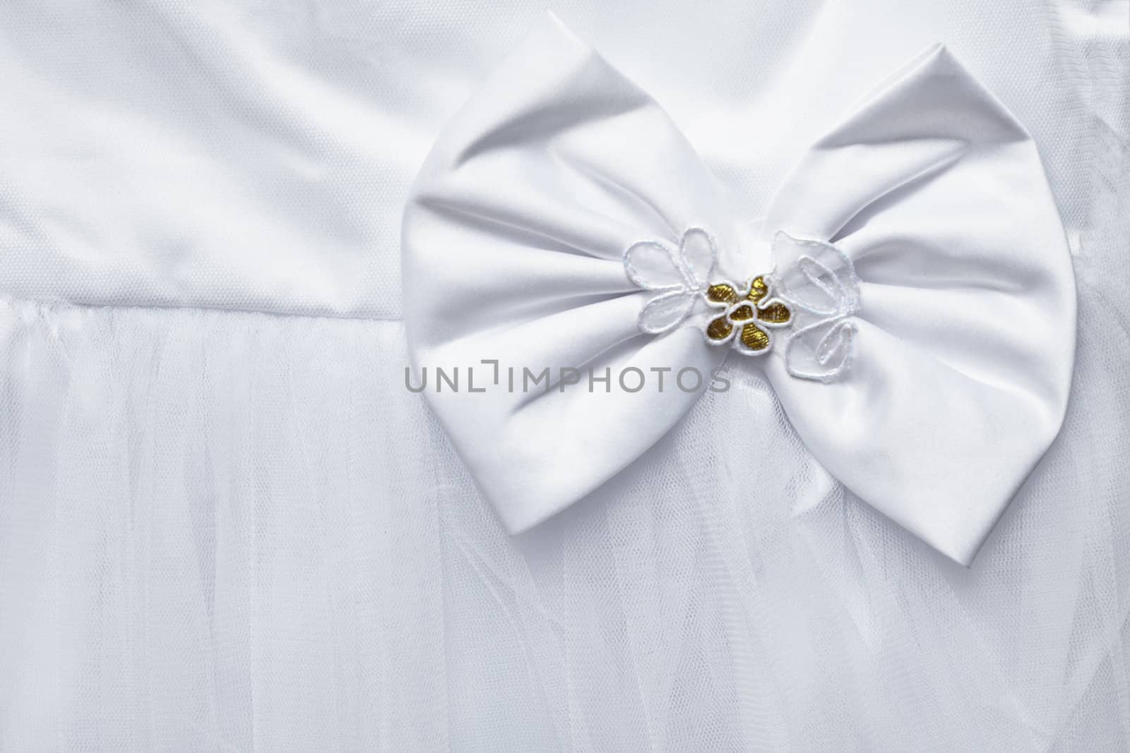 Big bow decorating the white dress - background
