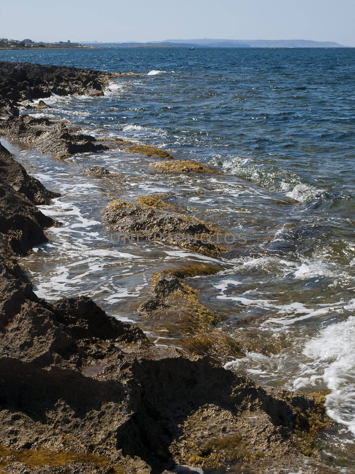 Detail of a rocky reef in Malta with beautiful crystal clear ocean water