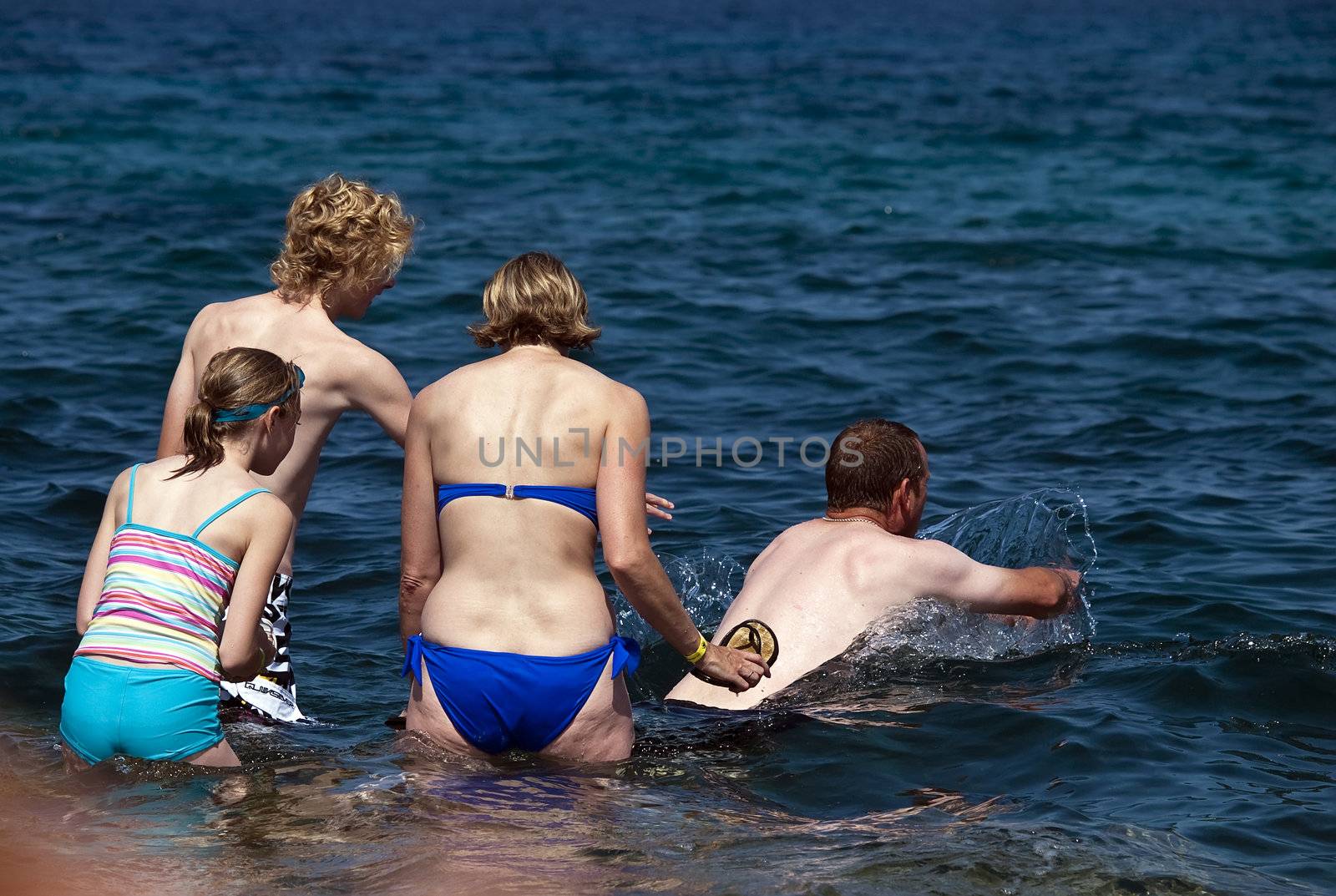 A family enjoys the crystal clear Mediterranean waters of Malta