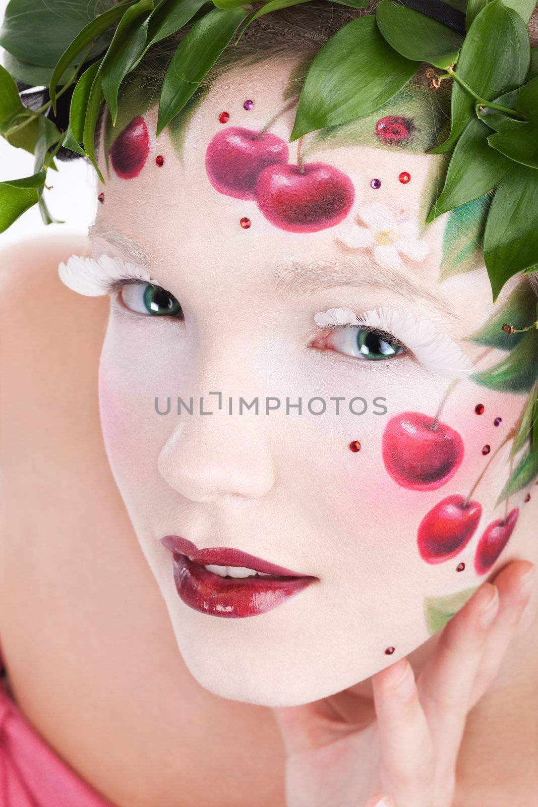 Closeup portrait of woman's face with a fantasy cherry makeup