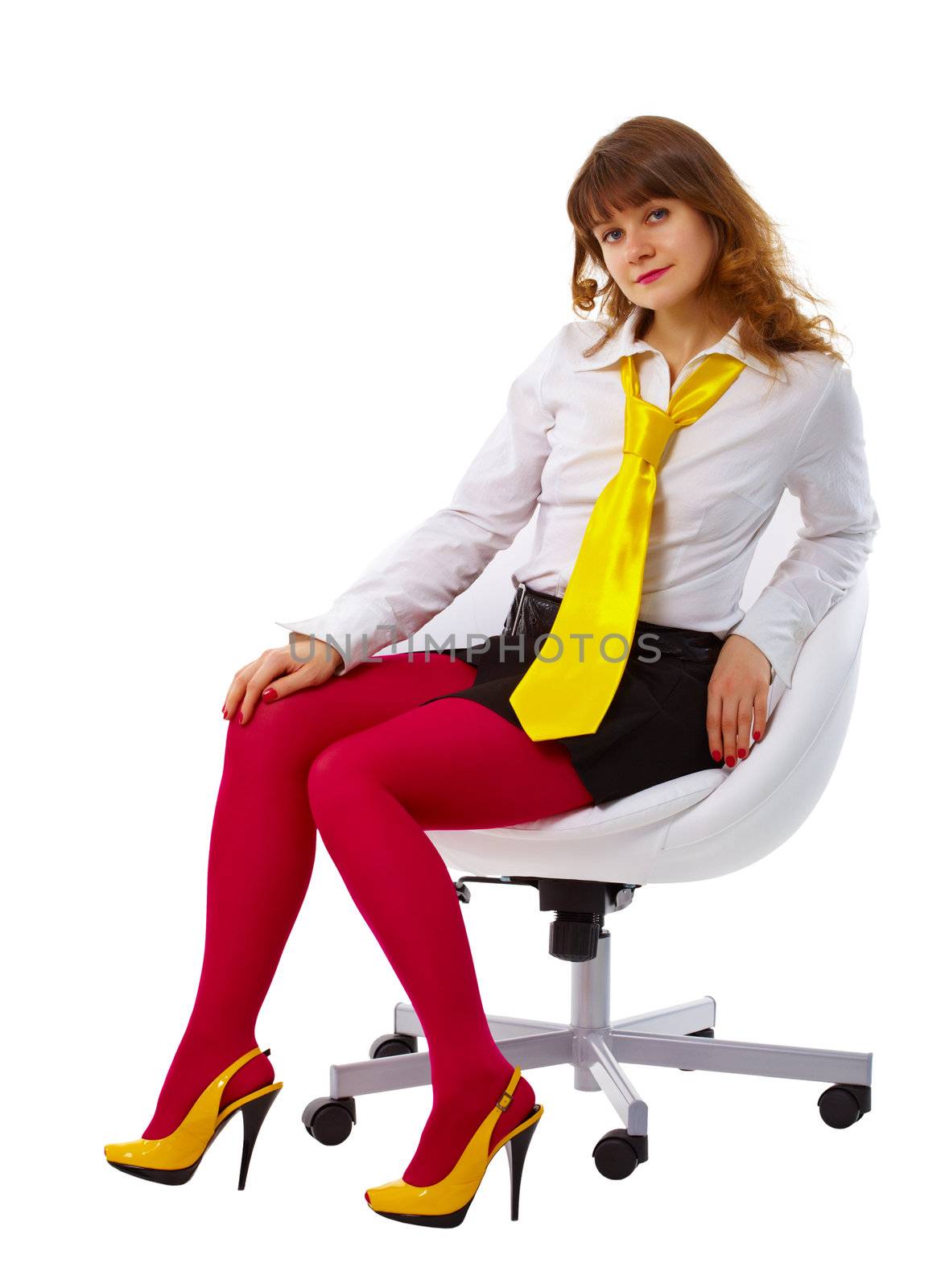 Beautiful young woman in bright clothes sitting in a chair isolated on white background