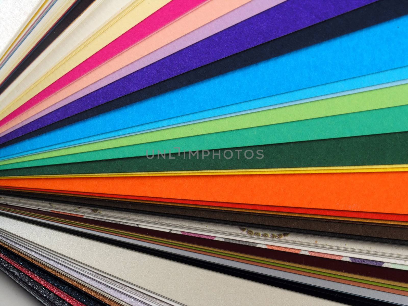 Colored samples of different papers on white background, business cards