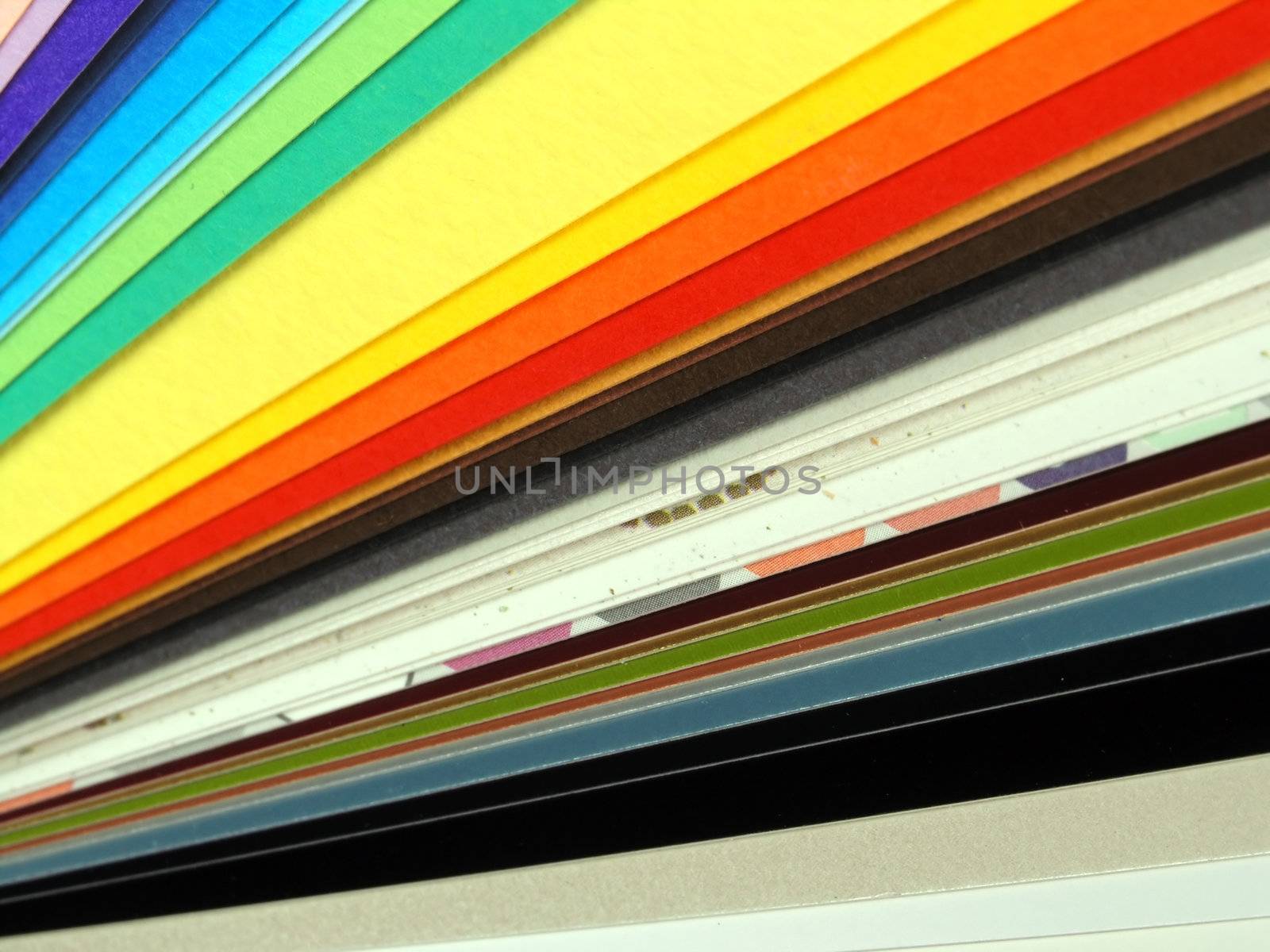 Colored samples of different papers on white background, business cards