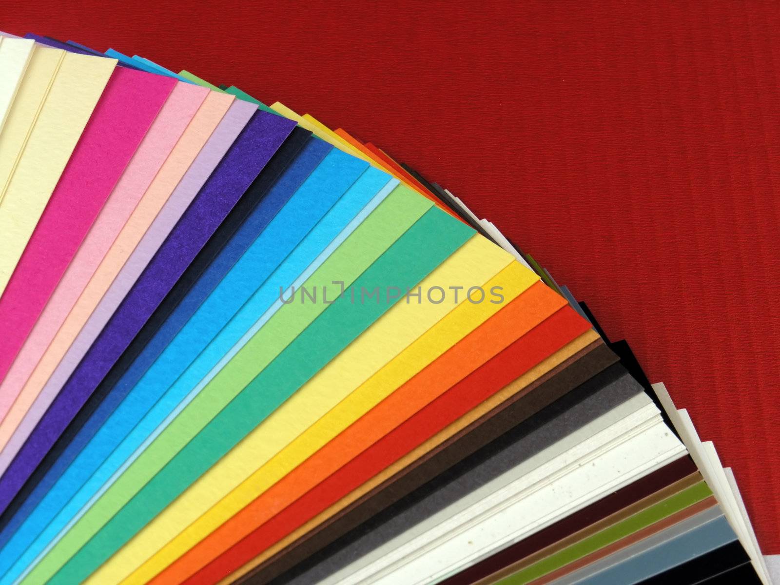 Colored samples of different papers on white background, business cards