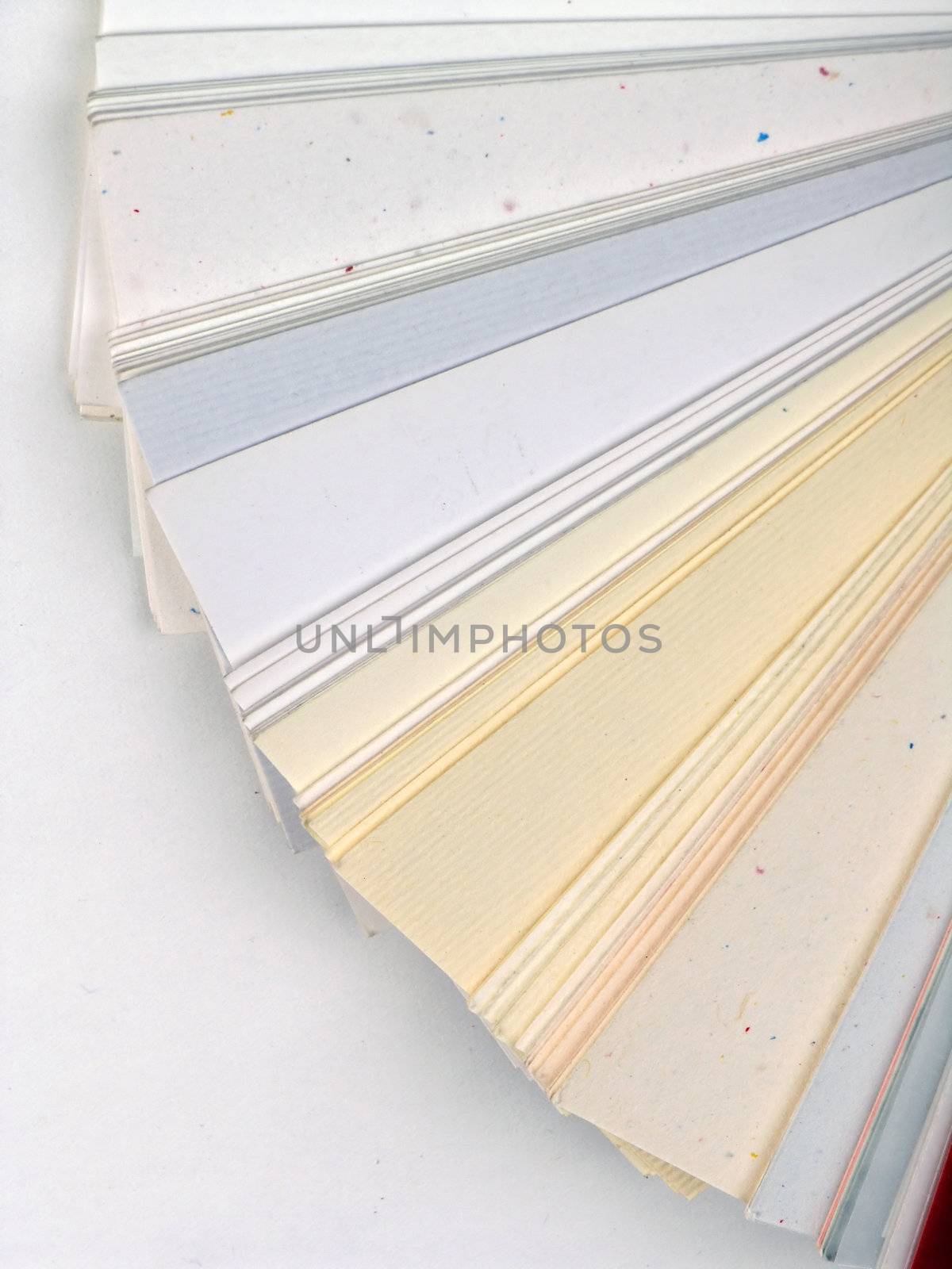 Colored samples of different papers on white background, business cards