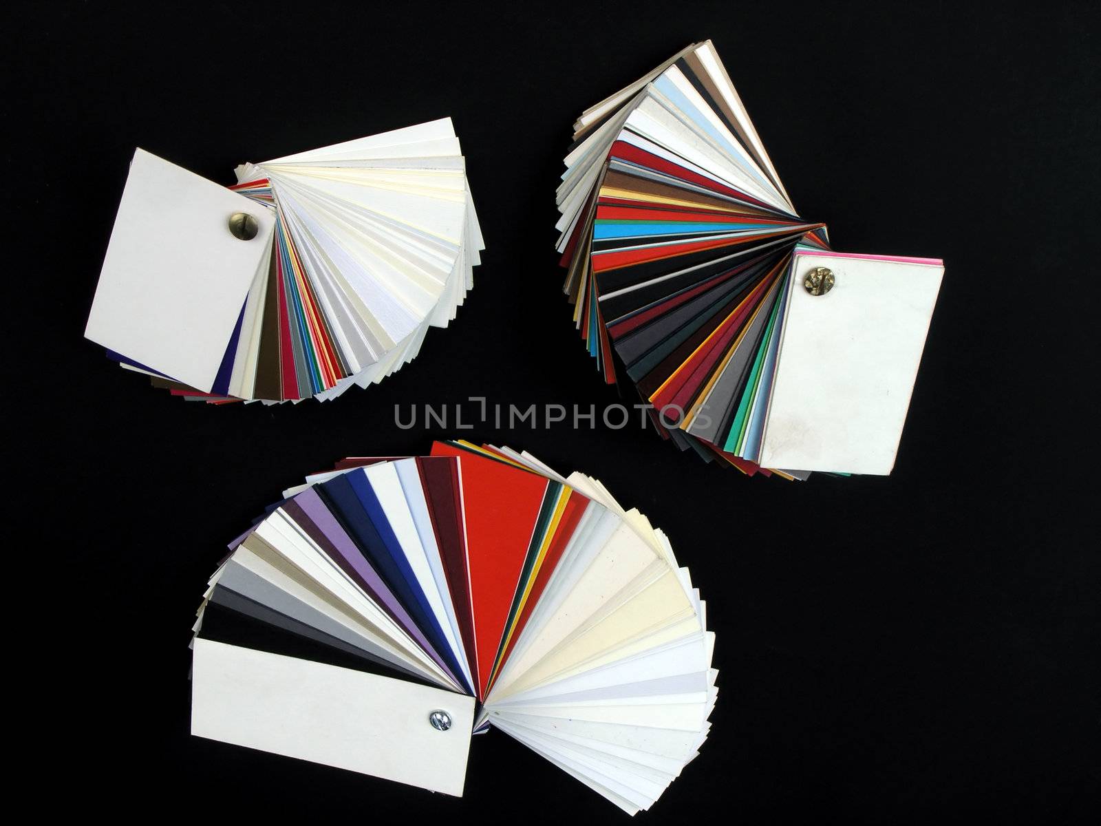 Colored samples of different papers on black background