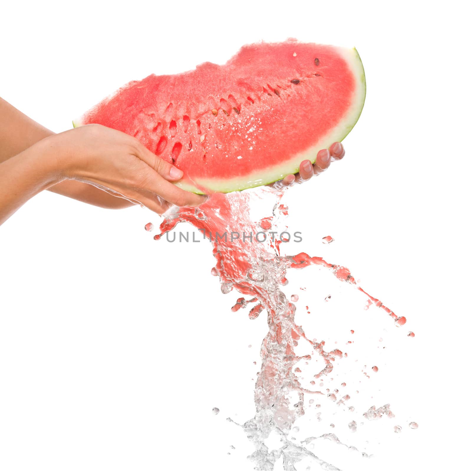 a segment of watermelon in the hands 
