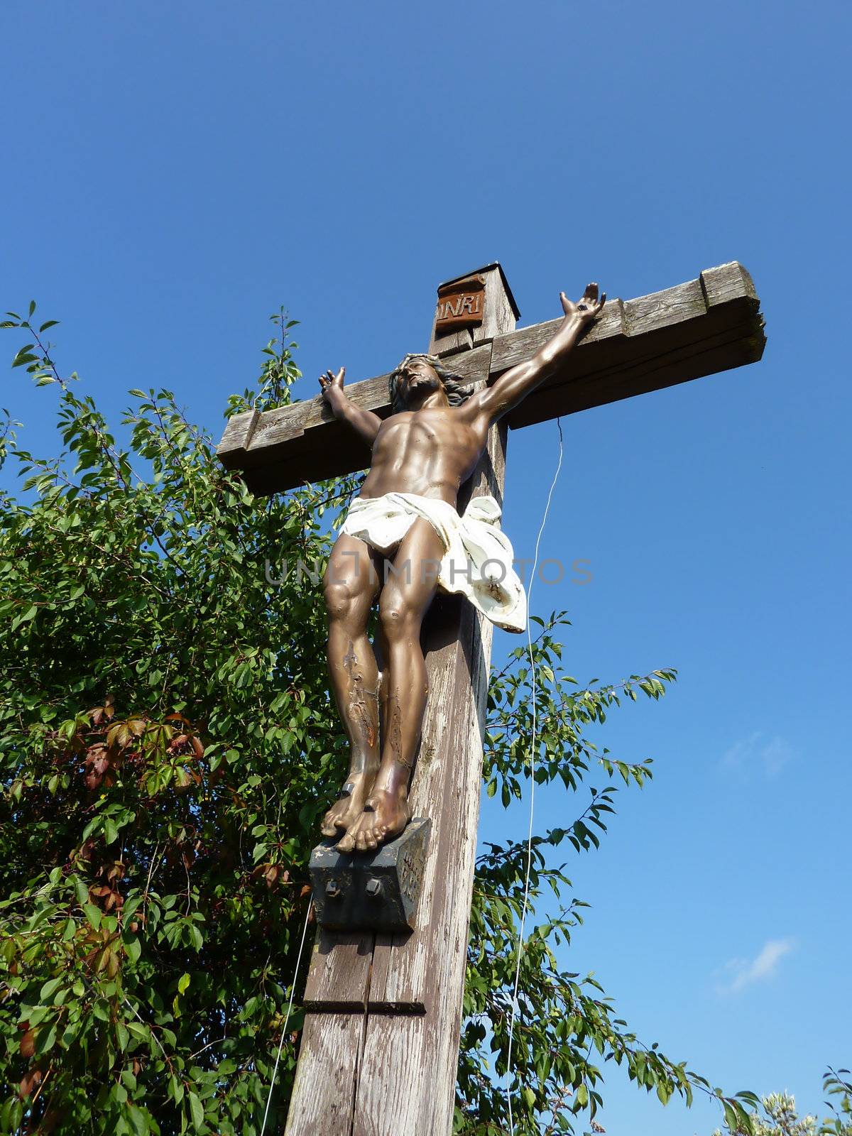 Jesus on a wood cross with blue sky