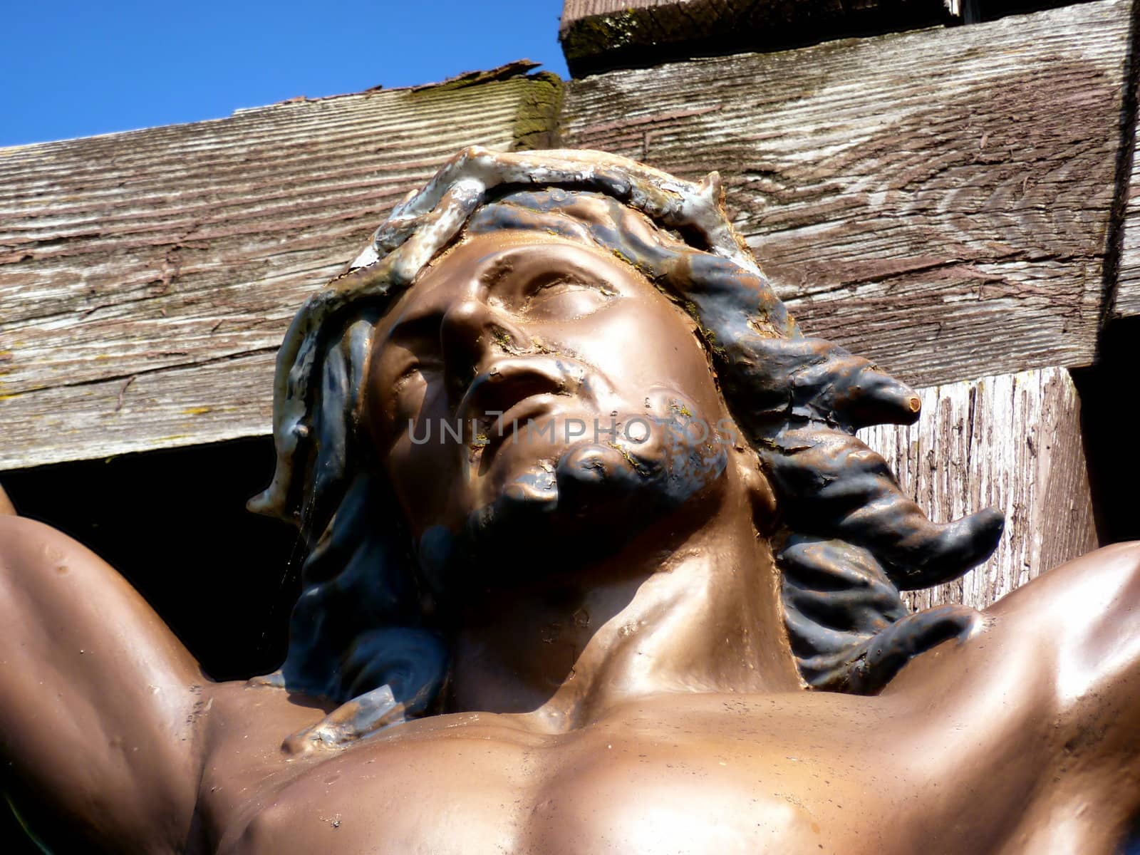 Close up of Jesus' face on a wood cross