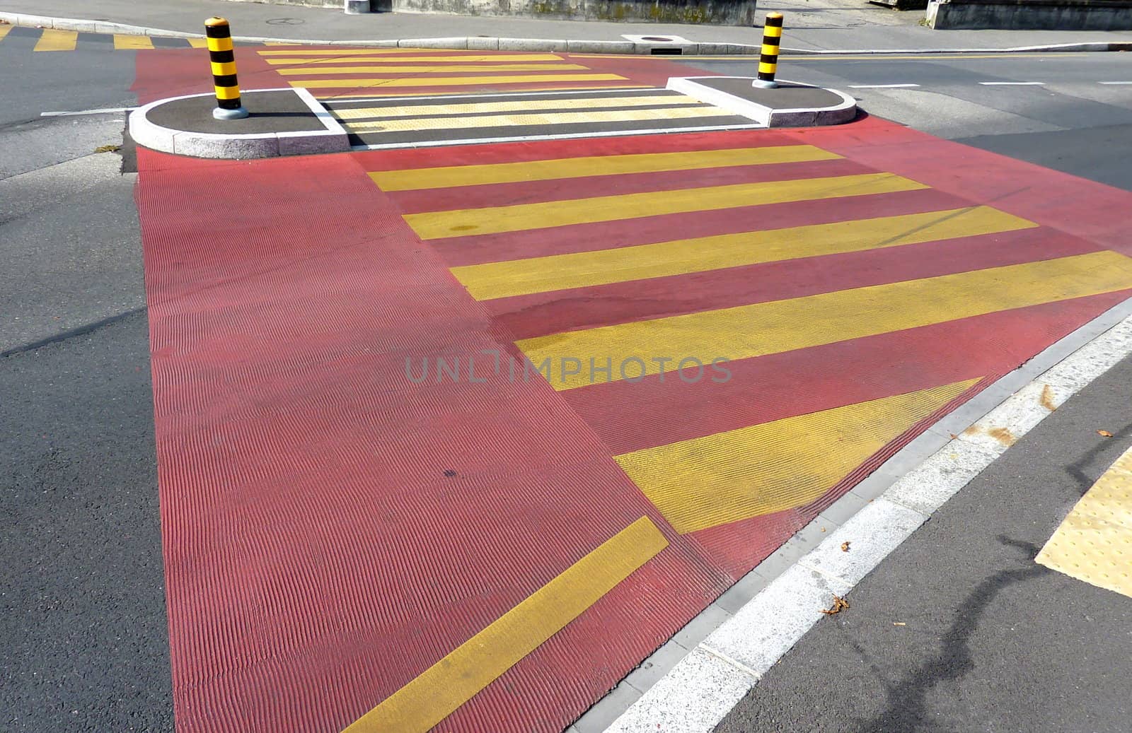 Red and yellow pedestrian crossing in a street
