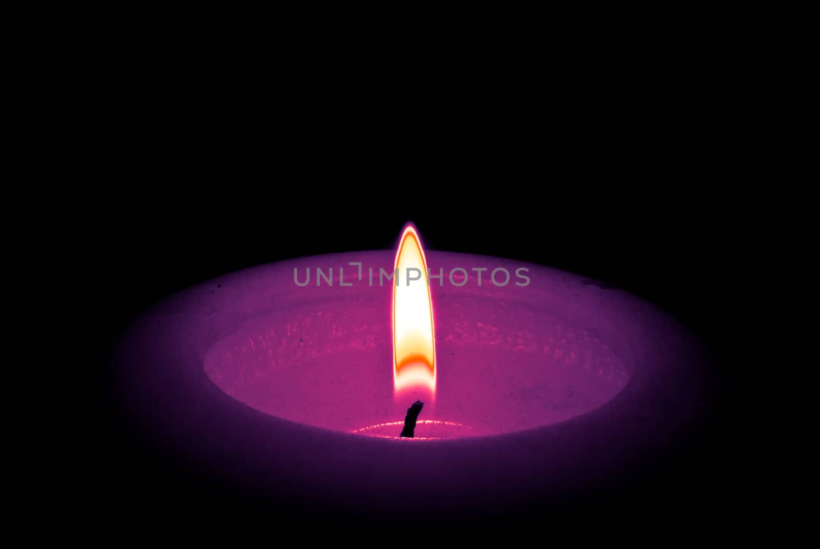The candle isolated on black background
