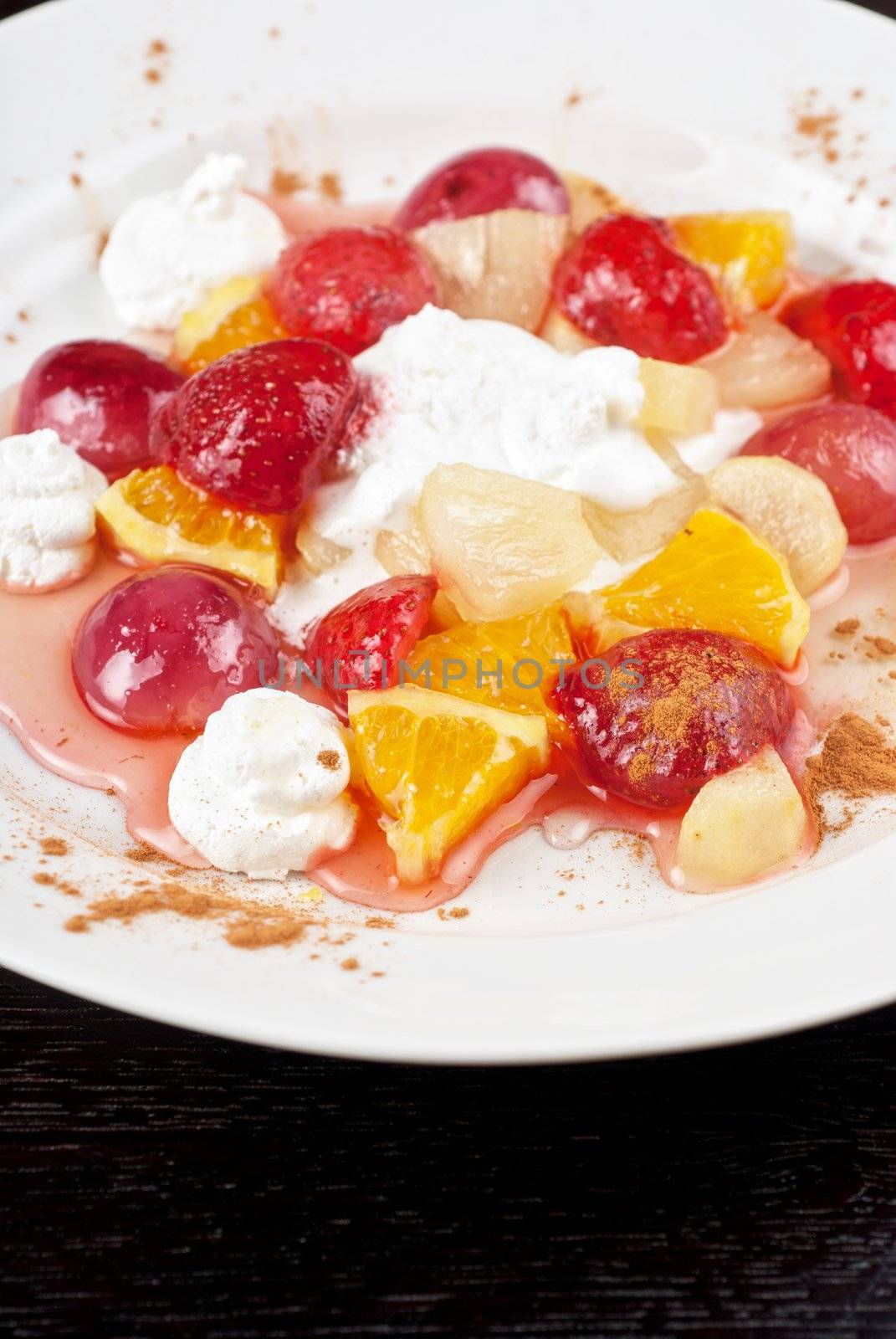 fruit salad of pineapple, grape, orange and strawberry with whipped cream