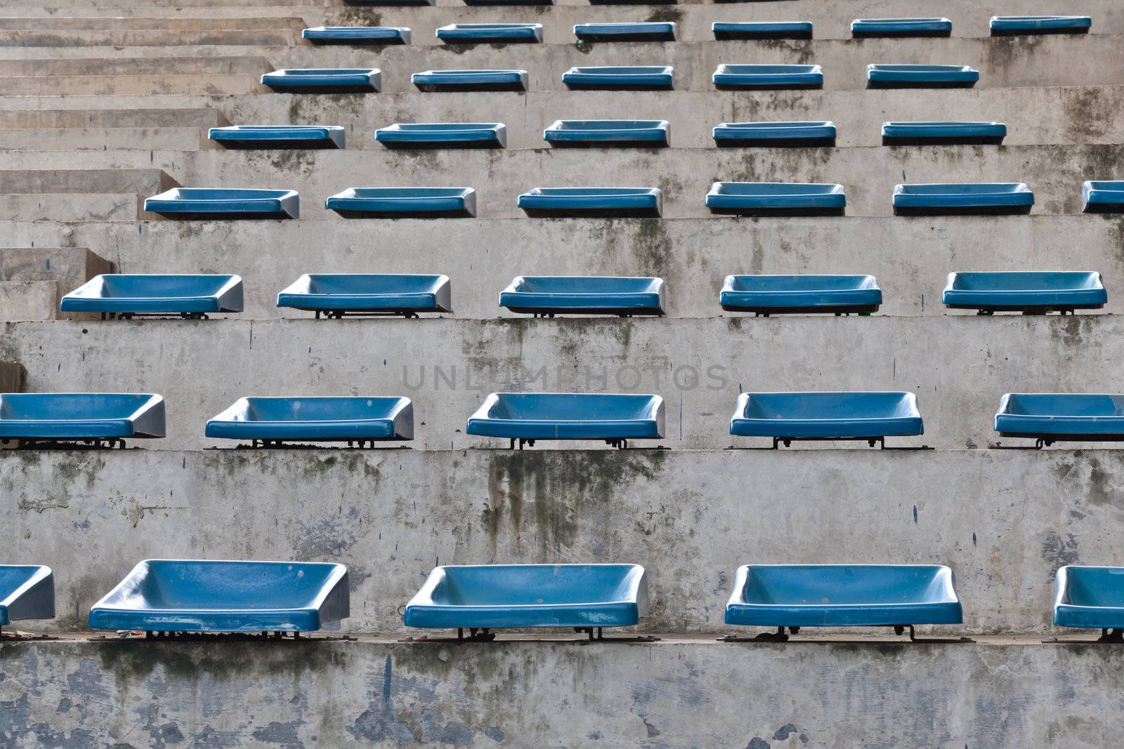 old plastic blue seats on stadium by FrameAngel