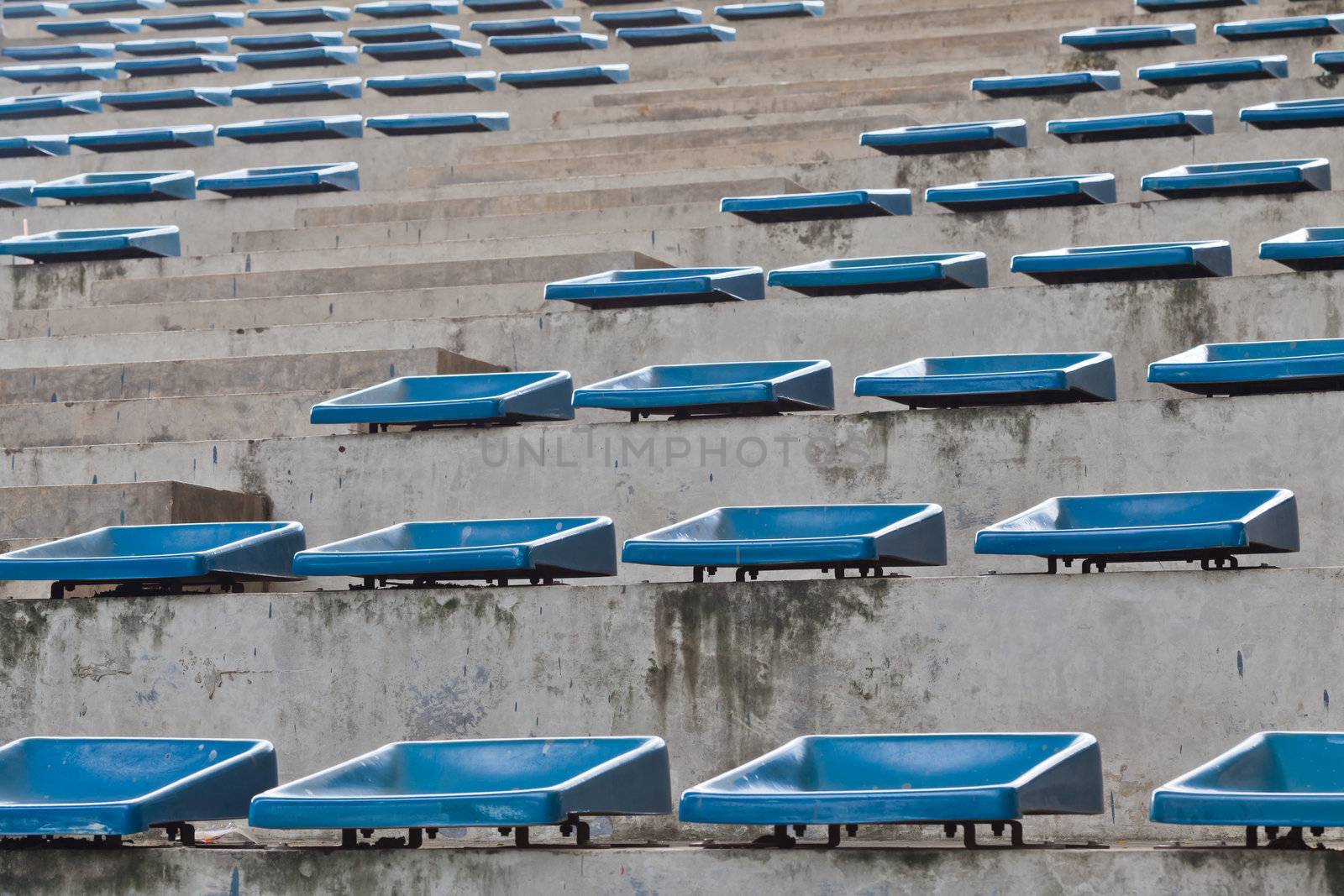 old plastic blue seats on stadium by FrameAngel