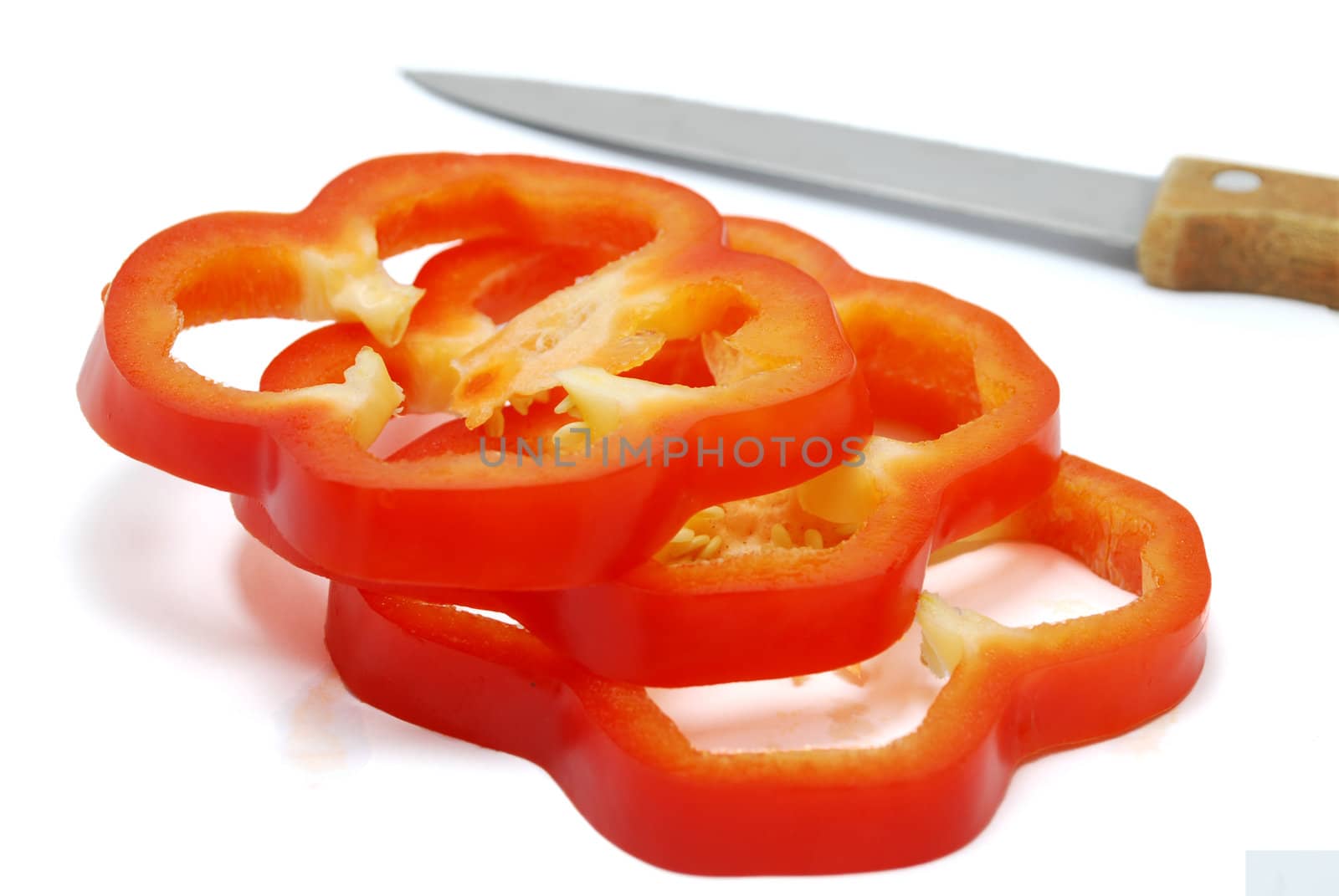 Isolated Sliced Red Pepper with Knife on White Background