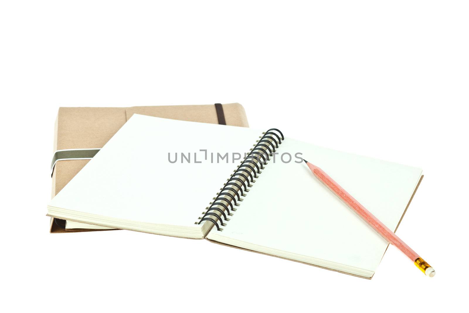 Isolated Light cream color paper note book on brown book and pen by FrameAngel