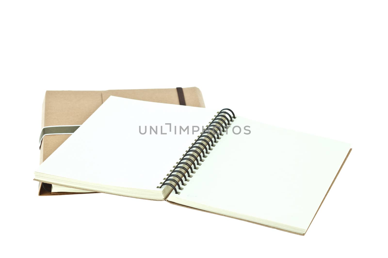 Isolated Light cream color paper note book on brown book by FrameAngel