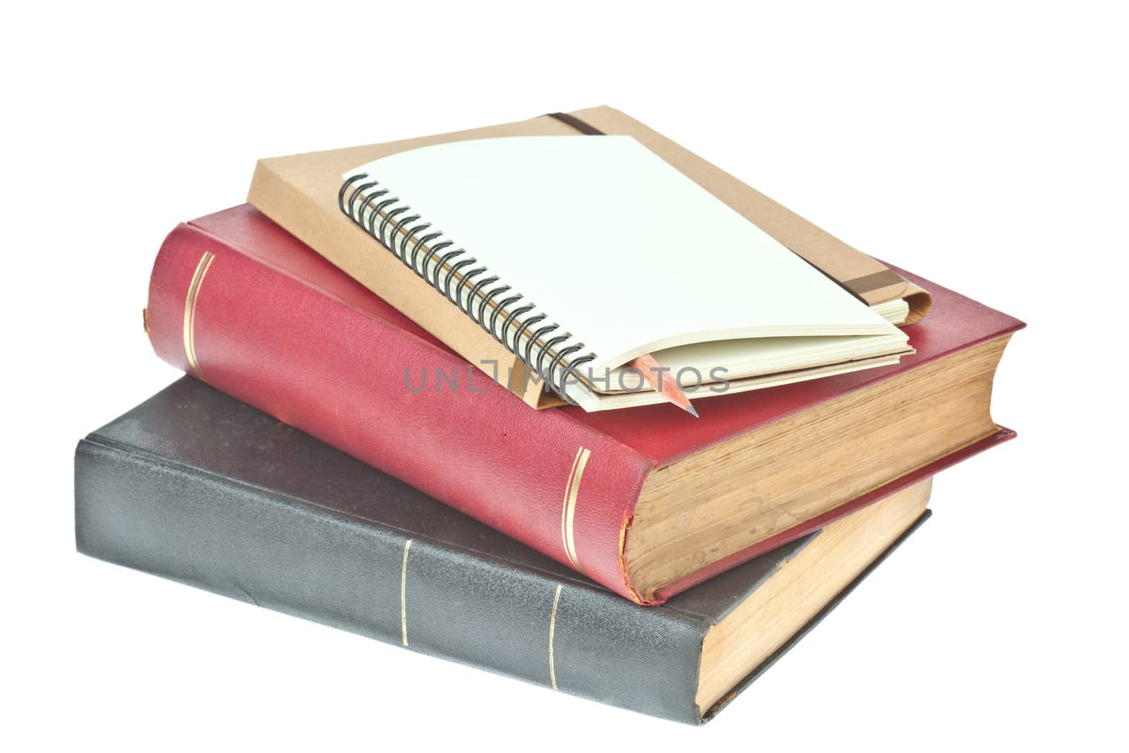 Pencil in, cream colored paper notebook and book as background