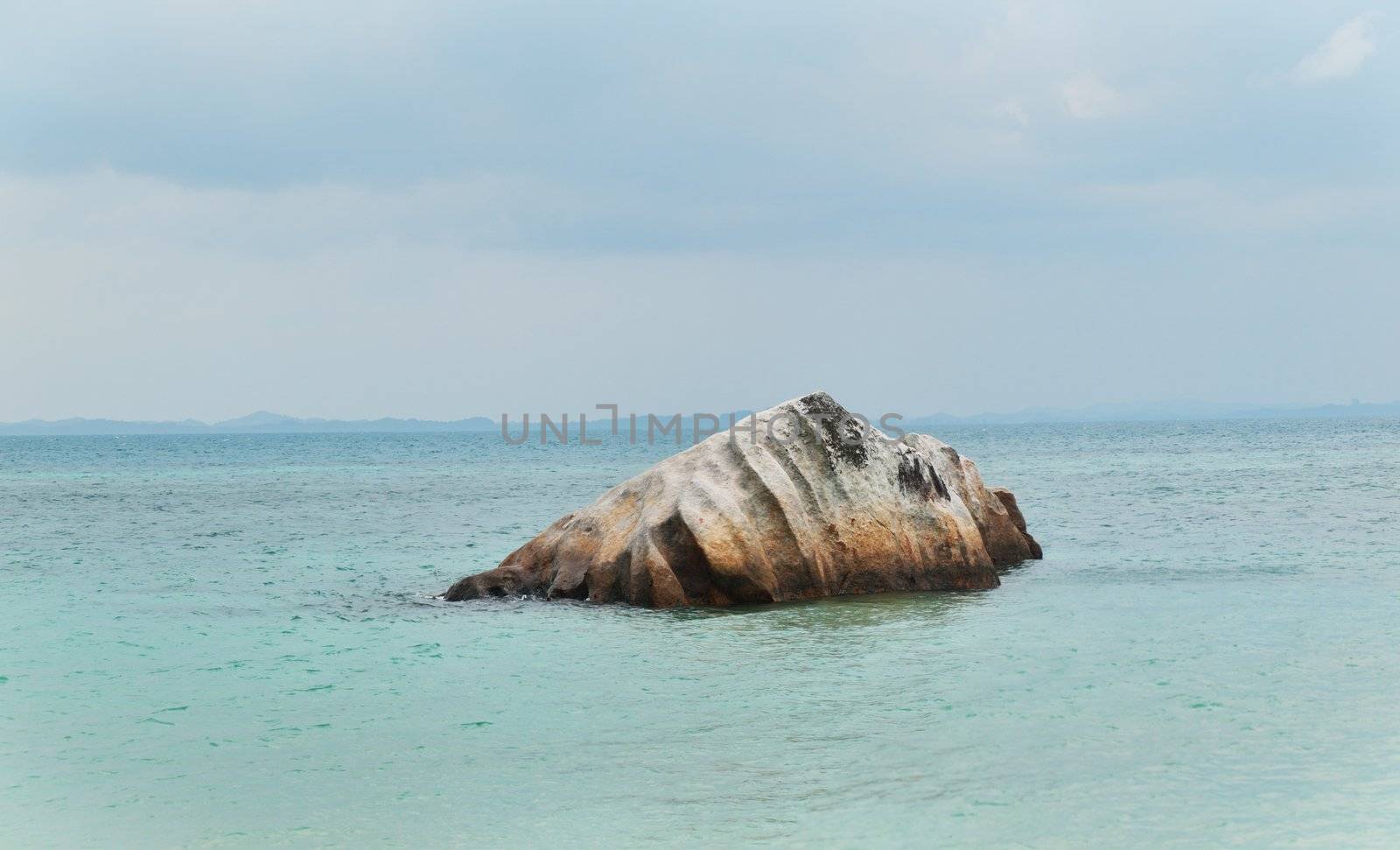 Big rock offshore from a small island in Malaysia