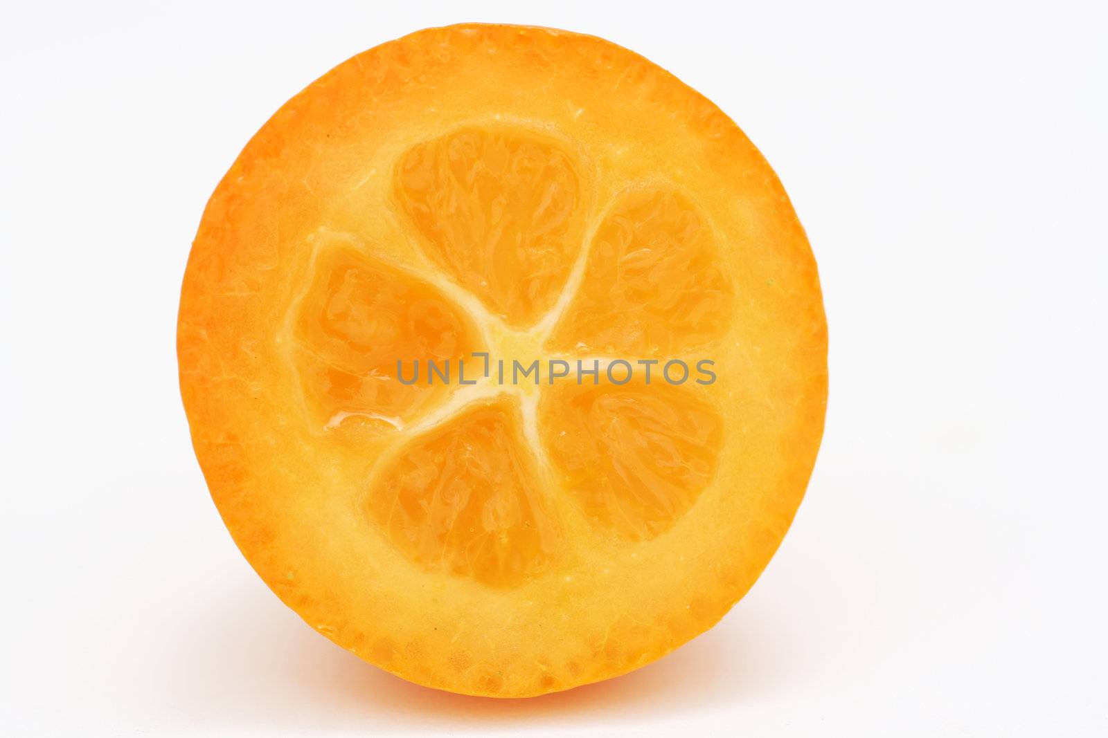 a cross section of a kumquat isolated on a white background